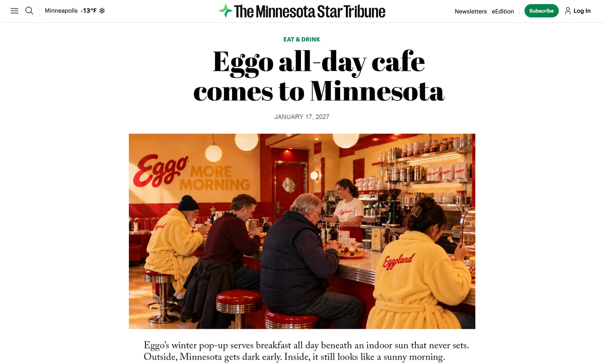 Mock Minnesota Star Tribune article headlined “Eggo all-day cafe comes to Minnesota,” with a photo of guests in yellow Eggoland robes at the counter